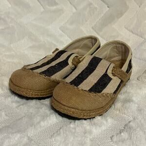 Black and tan striped slip-on shoes